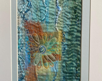 Framed Fabric Collage inspired by the coast of the Mediterranean.  Hand and machine stitched.