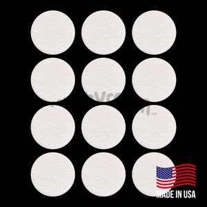 May include: Twelve white round filter paper discs arranged in a grid pattern on a black background. The filter paper is made in the USA.