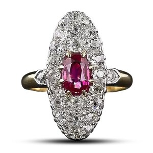 May include: A gold ring with a large oval ruby surrounded by a halo of smaller diamonds.