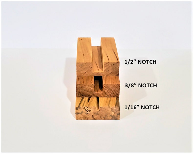 May include: Four wooden blocks stacked on top of each other, each with a different sized notch cut out. The notches are labeled 1/16", 3/8", and 1/2".