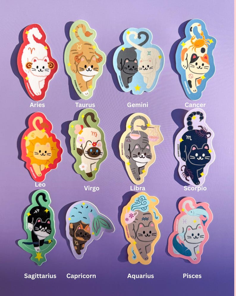 May include: A collection of twelve cat-themed zodiac stickers. Each sticker features a unique cat illustration representing a zodiac sign, with the sign's name printed below. The stickers have a colorful, cartoonish design.