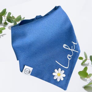 May include: A blue bandana with a white daisy and the name "Lofi" embroidered in white.