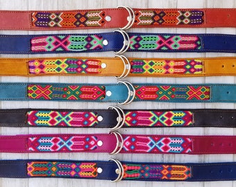 May include: Eight colorful dog collars with leather straps and metal D-rings. The collars feature a woven pattern with bright colors like red, yellow, blue, green, and pink. The brand name "CALAVERA Handmade for Pets" is printed on a white label above the collars.