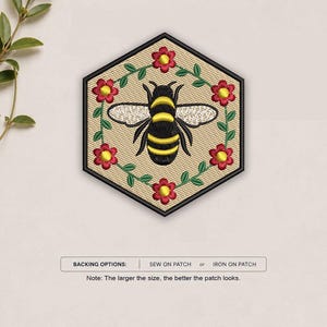 May include: A hexagonal embroidered patch featuring a central black and yellow bee surrounded by a wreath of green vines and red flowers with yellow centers. The text below reads: BACKING OPTIONS: SEW ON PATCH or IRON ON PATCH.