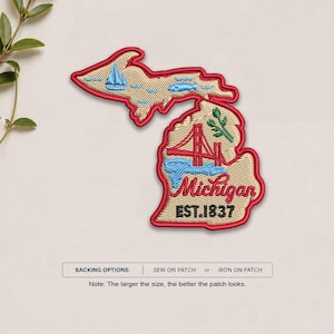 May include: An embroidered patch shaped like the state of Michigan with a red border. It features a blue sailboat, a blue fish, a red bridge, green leaves, and the text Michigan EST. 1837. Below, a label reads BACKING OPTIONS: SEW ON PATCH or IRON ON PATCH.