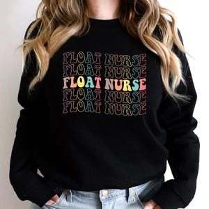 May include: Black sweatshirt with the text "FLOAT NURSE" repeated five times in a rainbow color scheme.