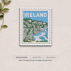 May include: A rectangular embroidered patch shaped like a postage stamp featuring the word IRELAND in white text above a landscape of green cliffs and blue ocean waves. The patch has a white scalloped border and includes text for backing options.