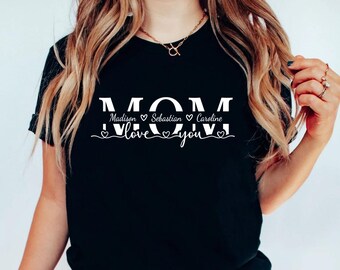 May include: Black t-shirt with white text that reads "MOM" with the names "Madison", "Sebastian", and "Caroline" and the phrase "love you" with hearts.