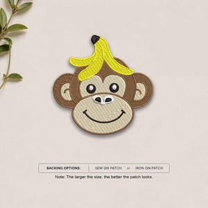 May include: An embroidered patch featuring a brown monkey face with a yellow banana peel on its head. The patch has black stitched eyes, a white muzzle, and a black smile. Text below reads: BACKING OPTIONS: SEW ON PATCH or IRON ON PATCH.