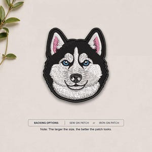 May include: An embroidered patch featuring the head of a Siberian Husky with black and white fur, bright blue eyes, and pink-tinted ears. Below the patch, text reads: BACKING OPTIONS: SEW ON PATCH or IRON ON PATCH. Note: The larger the size, the better the patch looks.