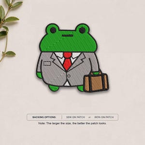 May include: An embroidered patch featuring a green frog wearing a grey suit, a white shirt, and a red tie, while holding a brown briefcase. The text below reads: BACKING OPTIONS: SEW ON PATCH or IRON ON PATCH. Note: The larger the size, the better the patch looks.