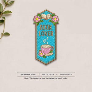May include: A vertical embroidered patch with a bright blue background, featuring an open book, pink flowers, and a pink coffee cup with steam. The text BOOK LOVER is stitched in brown. Below, a label reads BACKING OPTIONS: SEW ON PATCH or IRON ON PATCH.