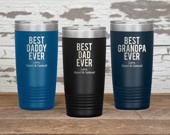 May include: Three stainless steel tumblers with different colors and personalized text. The blue tumbler says "Best Daddy Ever", the black tumbler says "Best Dad Ever", and the navy blue tumbler says "Best Grandpa Ever". Each tumbler has the text "Love, Hazel & Samuel" at the bottom.