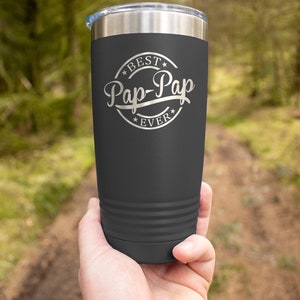 May include: A dark gray stainless steel tumbler with a silver inscription that reads "Best Pap-Pap Ever" in a circle with stars.