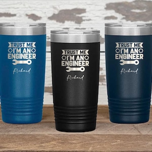 May include: Three stainless steel tumblers with a black, blue, and dark blue finish. Each tumbler features a white design with the text "Trust me I'm an engineer" and a wrench graphic. The name "Richard" is printed below the graphic.