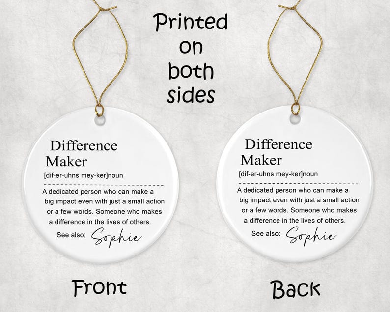 May include: Two-sided white ceramic ornament with gold string. The ornament features the definition of "Difference Maker" in black text. The front and back of the ornament are visible, with the word "Front" and "Back" at the bottom.