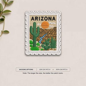 May include: A rectangular embroidered patch shaped like a postage stamp featuring the text ARIZONA in black. The design depicts a green saguaro cactus, a desert landscape with a blue river, and an orange sun. Backing options include sew-on or iron-on.
