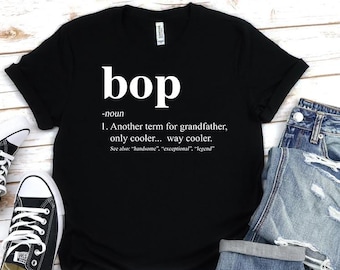 May include: Black t-shirt with white text that reads "bop -noun 1. Another term for grandfather, only cooler... way cooler. See also: "handsome", "exceptional", "legend""