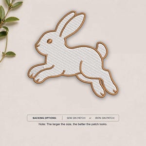 May include: An embroidered patch in the shape of a leaping rabbit with white thread and a brown stitched border. Below the rabbit, text reads: BACKING OPTIONS: SEW ON PATCH or IRON ON PATCH. Note: The larger the size, the better the patch looks.