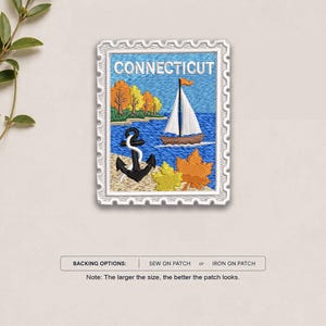 May include: A rectangular embroidered patch shaped like a postage stamp featuring the word CONNECTICUT. The design shows a sailboat on blue water, a black anchor on a sandy shore, autumn trees, and yellow and orange maple leaves.