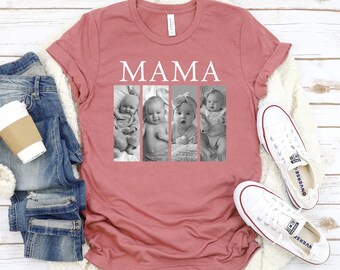 May include: A dusty rose t-shirt with the word "MAMA" in white block letters above four black and white baby photos. The shirt is laid on a white surface with a pair of blue jeans, a coffee cup, and white sneakers.