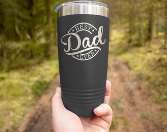 May include: A dark gray stainless steel tumbler with a silver inscription that reads "Best Dad Ever" in a circle.