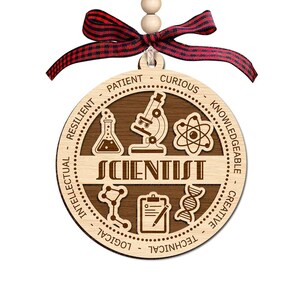 May include: A wooden scientist ornament with a red and black plaid ribbon. The ornament features the word "SCIENTIST" and science-related icons. The border includes words like "Patient", "Curious", "Knowledgeable", "Creative", "Technical", "Logical", "Intellectual", and "Resilient".