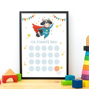May include: A printable chart with a raccoon superhero character wearing a red cape and blue suit. The chart has 25 circles for marking progress and the text "ICH SCHAFFE DAS!" in German. The chart is framed in black.