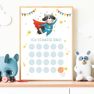 May include: A printable chart featuring a cartoon raccoon superhero with a blue cape and yellow star. The chart has 20 circles for marking progress and the text "ICH SCHAFFE DAS!" at the top.