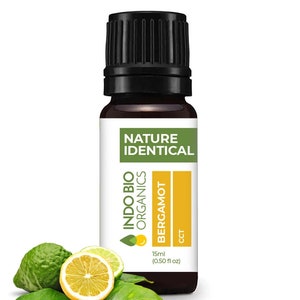 May include: A brown glass bottle of Indo Bio Organics Bergamot essential oil. The bottle is labelled "Nature Identical" and has a yellow and green label with the text "Bergamot" and "15ml (0.50 fl oz)".