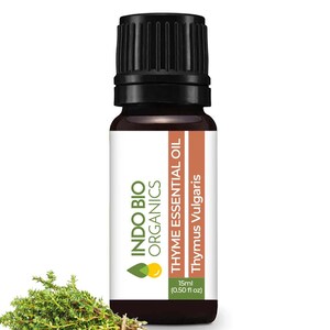 May include: A brown glass bottle of Thyme Essential Oil by Indo Bio Organics. The bottle is labelled with the product name, "Thymus Vulgaris", and the size, "15ml (0.50 fl oz)". A sprig of fresh thyme is in the foreground.