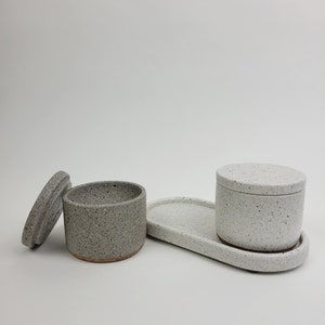 May include: A rustic wooden sign with the text "Welcome to our home" in a handwritten style. The sign has a distressed finish and a simple, inviting design, suitable for a front porch or entryway.