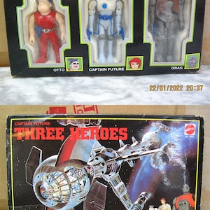 May include: A vintage box set of Captain Future action figures. The box features a black background with the title "Three Heroes" in white letters. The box includes three figures: Otto, Captain Future, and Grag. The figures are shown in their respective poses. The box also includes a picture of the spaceship from the Captain Future series.