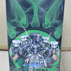 May include: A box featuring a black and green design with the text "Alien Resurrection" and images of black and silver action figures of the Alien and Predator characters.