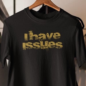 May include: Black t-shirt with a gold graphic that says "I have issues".