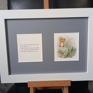 May include: A framed illustration of a squirrel with the text "Tus squirrels filled their little sacks with nuts. But Nutkin sat upon a big flat rock, and played ninepies with a crab apple and green fir-coses."