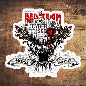 May include: A white sticker with a black and red graphic design. The words "RED TEAM" are at the top, with a heart and a face-like image below. The words "DEFENSE" and "OFFENSE" are on a banner.