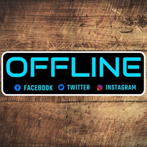 May include: A black and white sticker with the word "OFFLINE" in blue text. The sticker also includes icons for Facebook, Twitter, and Instagram.