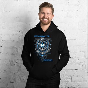 May include: Black hooded sweatshirt with a blue and gray graphic of a robot warrior's face. The graphic is surrounded by geometric shapes and the text "METASPLOIT III" and "WARRIOR".