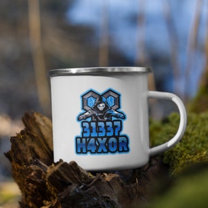 May include: White enamel camping mug with a blue and gray graphic of a hooded figure with the text "31337 H4XOR".