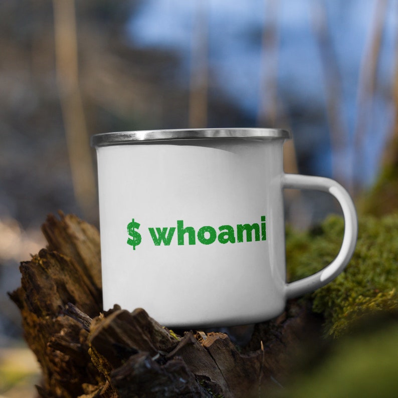 May include: White enamel camping mug with a green dollar sign and the text "whoami" printed on the side.