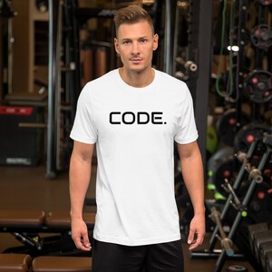 May include: White t-shirt with black text that reads "CODE."