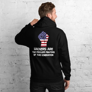 May include: Black hooded sweatshirt with a raised fist graphic in the colours of the American flag. The text "Hackers are the freedom fighters of this generation" is printed below the graphic.