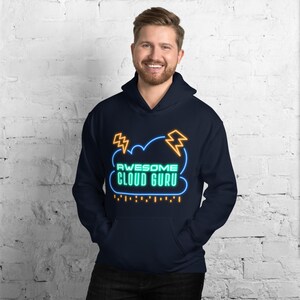 May include: A navy blue hoodie with a neon green and orange cloud graphic that says "Awesome Cloud Guru".