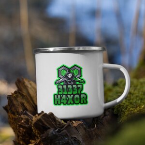 May include: White enamel camping mug with a green and black logo featuring a hooded figure and the text "31337 H4XOR".