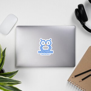 May include: A white sticker featuring a blue owl design made of small blue shapes. The owl has orange accents and the text "Google Cloud Platform" below it. The sticker is on a laptop.