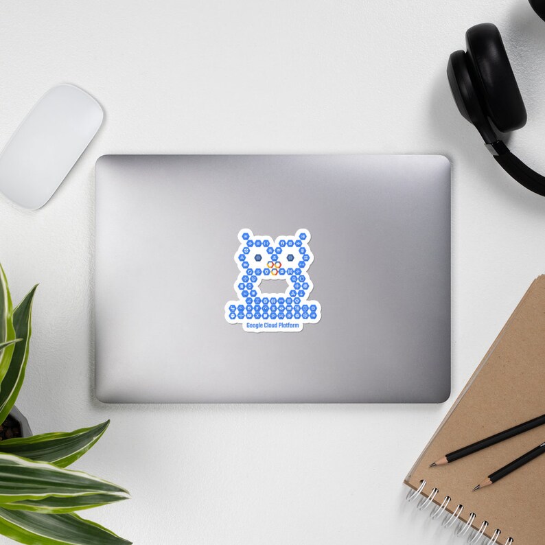 May include: A white sticker featuring a blue owl design made of small blue shapes. The owl has orange accents and the text "Google Cloud Platform" below it. The sticker is on a laptop.