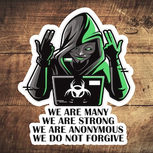 May include: A sticker featuring a masked figure in a black hooded cloak with green accents, raising two fingers. The figure is positioned in front of a laptop with a biohazard symbol. Text at the bottom reads: "WE ARE MANY WE ARE STRONG WE ARE ANONYMOUS WE DO NOT FORGIVE."