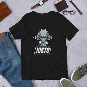 May include: Black t-shirt with a graphic of a grey alien with blue accents and the word "NIKTO" in a white box.