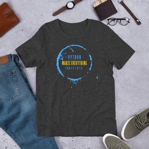 May include: Dark heather grey t-shirt with a blue coffee stain graphic. The graphic has the text "PYTHON MAKES EVERYTHING POSSIBLE" in yellow.